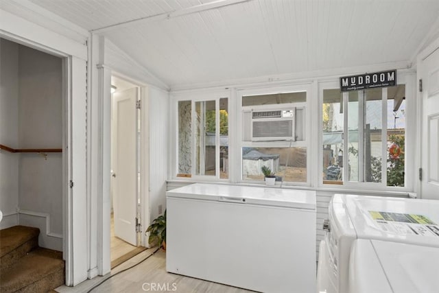 sunroom / solarium with washer and dryer, wood ceiling, and vaulted ceiling