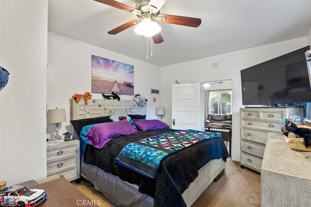 bedroom featuring ceiling fan and light carpet