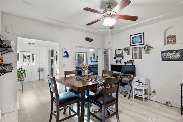 dining space featuring light hardwood / wood-style flooring and ceiling fan