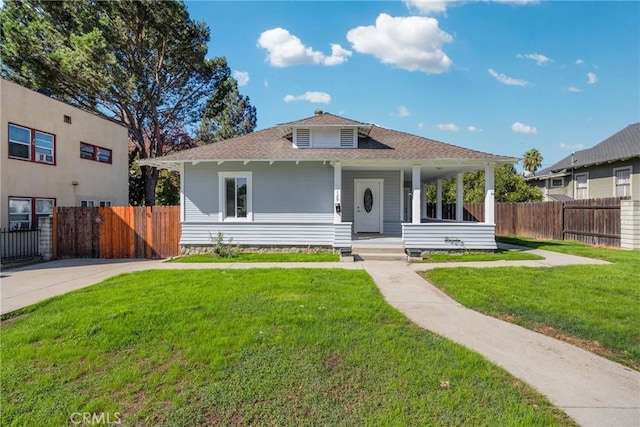 view of front of house with covered porch and a front lawn