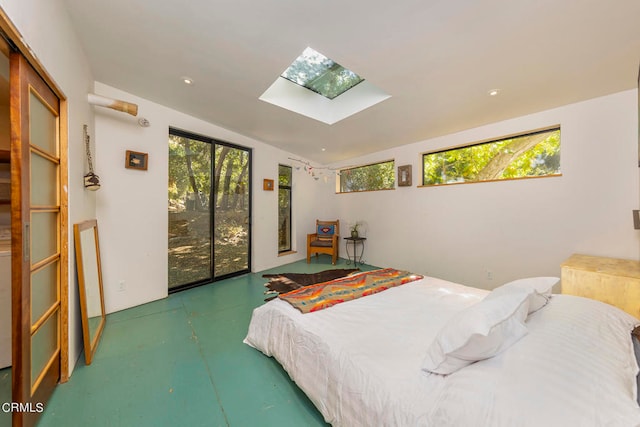 bedroom with vaulted ceiling with skylight and multiple windows