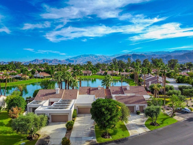 drone / aerial view with a water and mountain view