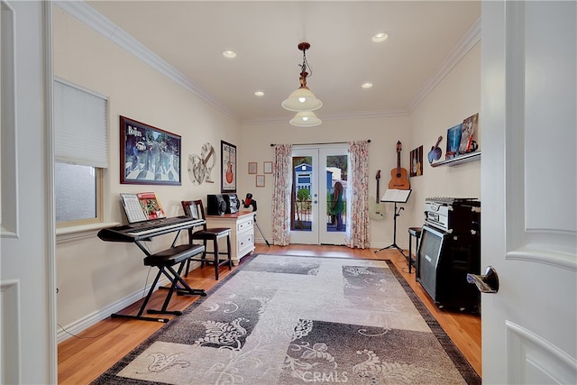 entryway featuring ornamental molding, french doors, and light wood-type flooring