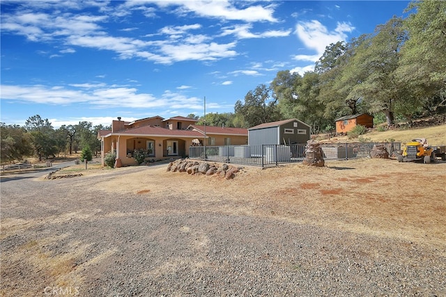 view of front of property with a storage shed