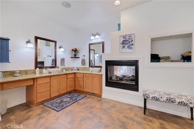 bathroom with vanity and a multi sided fireplace