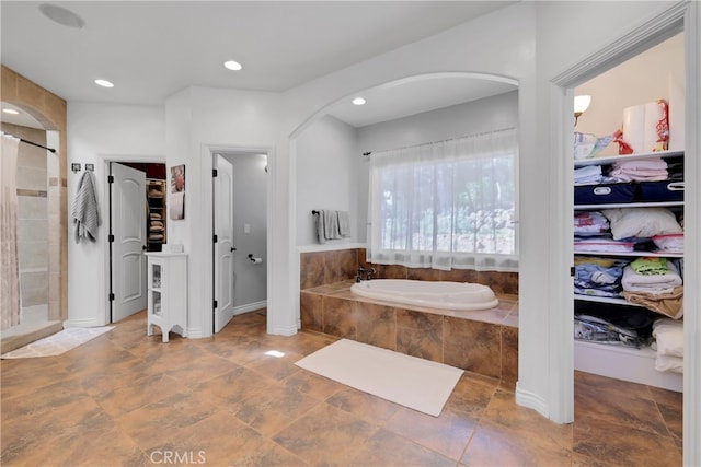 bathroom featuring tile patterned floors and separate shower and tub