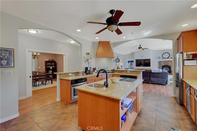 kitchen with stainless steel appliances, wood-type flooring, sink, and lofted ceiling