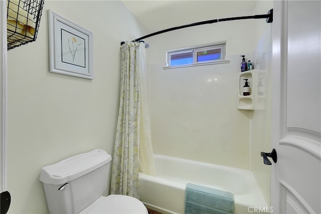 bathroom featuring shower / bath combination with curtain and toilet