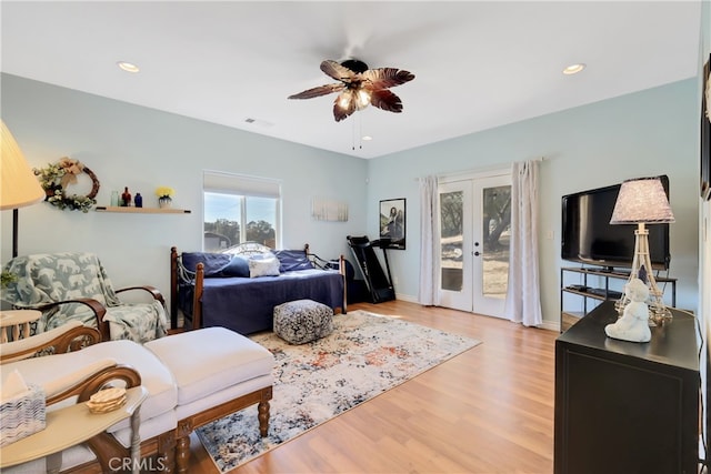 bedroom with light hardwood / wood-style flooring, french doors, access to exterior, and ceiling fan