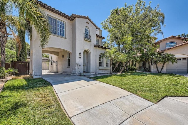 mediterranean / spanish house with a front yard and a garage