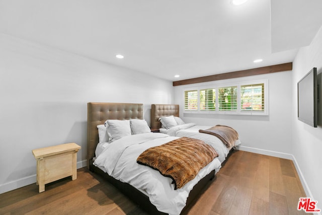 bedroom with dark hardwood / wood-style flooring