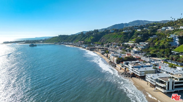 drone / aerial view with a view of the beach and a water and mountain view