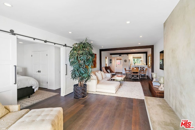 living room featuring dark hardwood / wood-style floors and a barn door