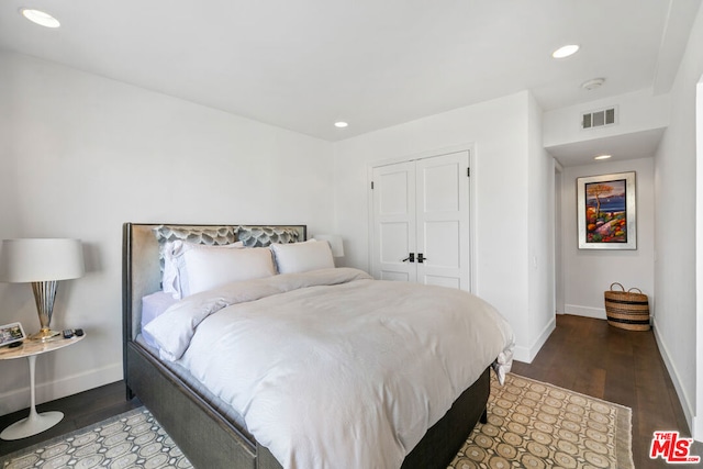 bedroom featuring a closet and dark hardwood / wood-style flooring