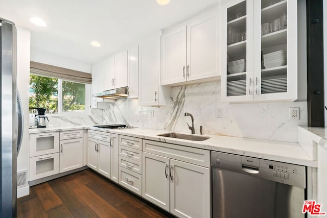 kitchen featuring light stone countertops, appliances with stainless steel finishes, dark hardwood / wood-style floors, and white cabinets