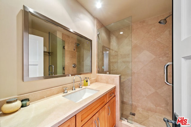 bathroom featuring vanity and an enclosed shower