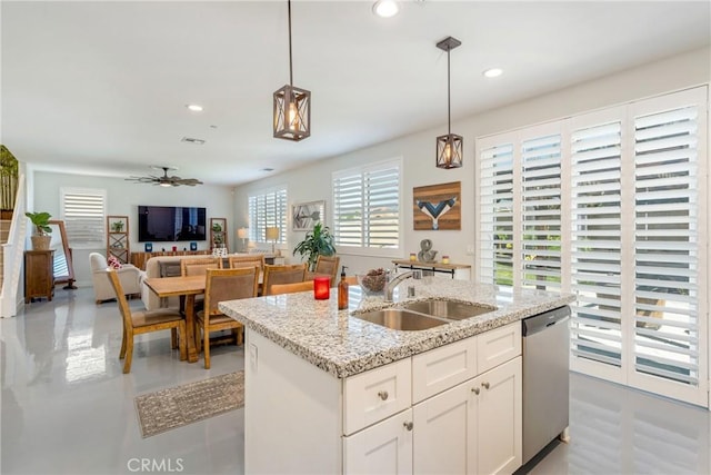 kitchen featuring stainless steel dishwasher, decorative light fixtures, sink, and white cabinetry