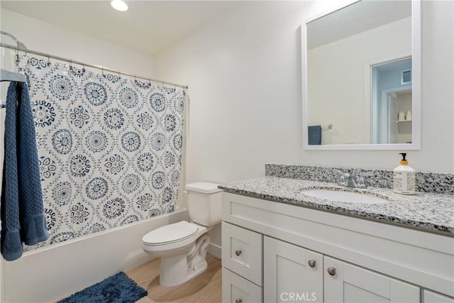 full bathroom featuring hardwood / wood-style floors, toilet, vanity, and shower / tub combo with curtain