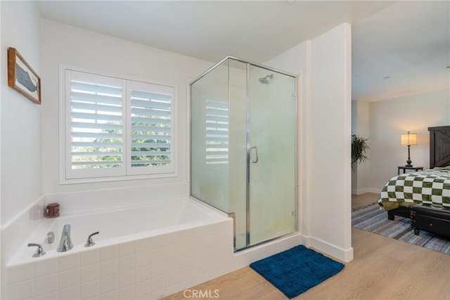 bathroom featuring independent shower and bath and hardwood / wood-style flooring