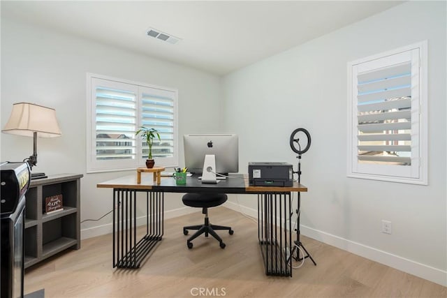 office space with light wood-type flooring