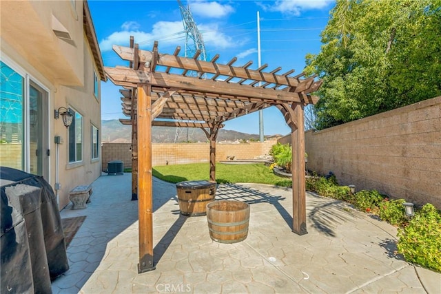 view of patio / terrace with a mountain view, central AC, and a pergola