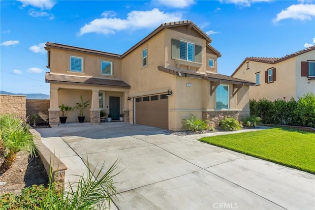 view of front of property with a front yard and a garage