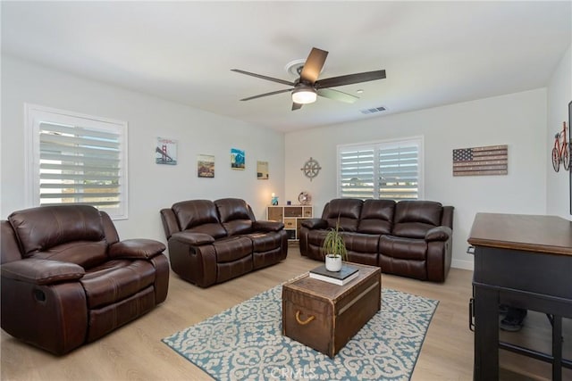 living room featuring ceiling fan and light wood-type flooring