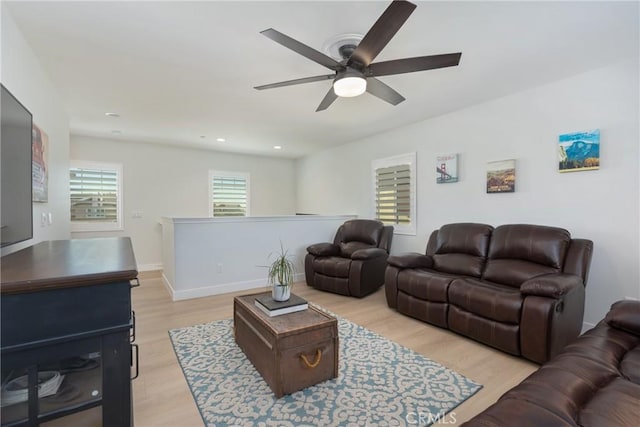 living room featuring light hardwood / wood-style floors and ceiling fan