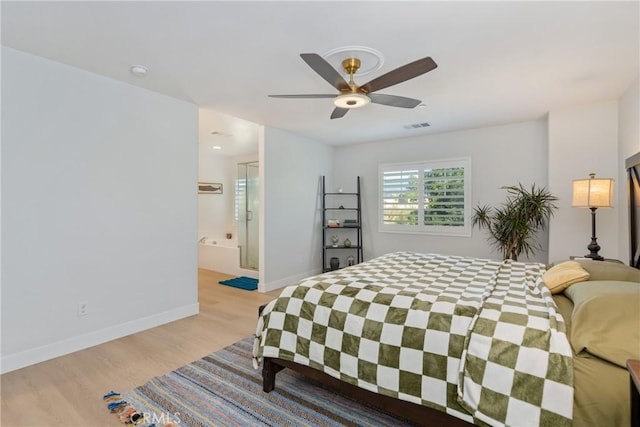 bedroom featuring ceiling fan, light hardwood / wood-style floors, and ensuite bathroom