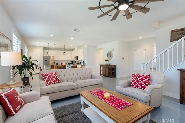 living room with ceiling fan and concrete floors