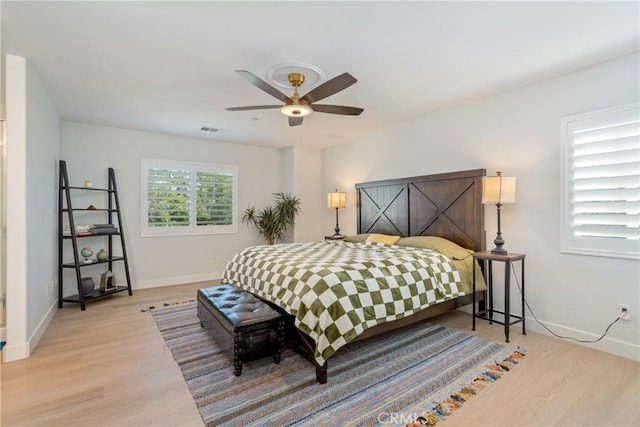 bedroom with ceiling fan and light hardwood / wood-style floors