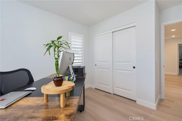 office area with light hardwood / wood-style floors