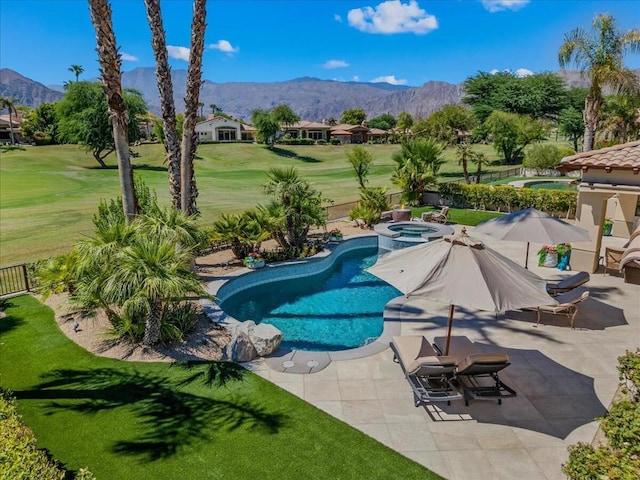 view of pool featuring a lawn, an in ground hot tub, a mountain view, and a patio