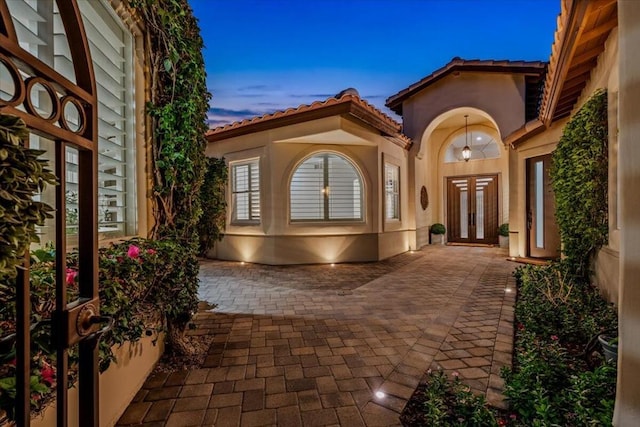 exterior entry at dusk with french doors