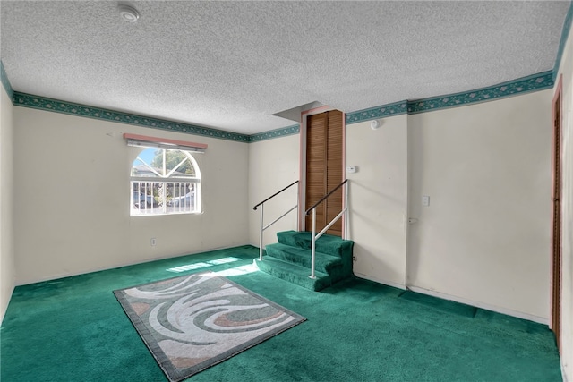 empty room featuring carpet and a textured ceiling