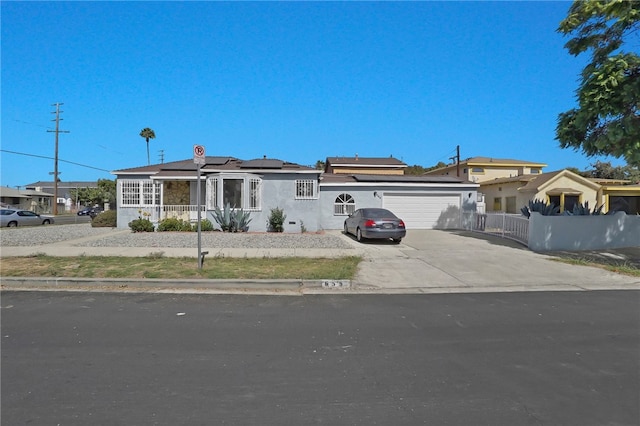 ranch-style house featuring a garage and solar panels