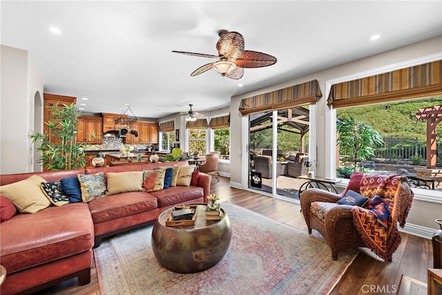 living room with hardwood / wood-style floors and ceiling fan