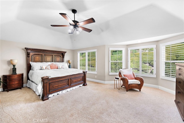 bedroom with ceiling fan, vaulted ceiling, and light colored carpet