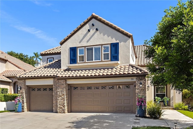 mediterranean / spanish house with a garage