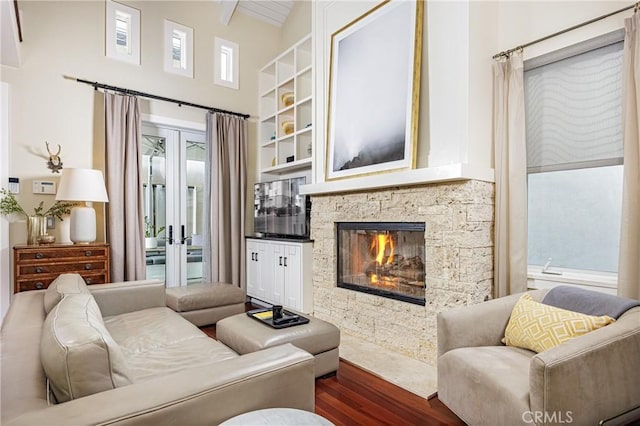 living room with lofted ceiling with beams, a fireplace, and dark wood-type flooring