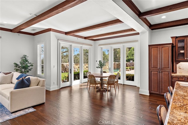 dining area featuring beamed ceiling, dark hardwood / wood-style floors, crown molding, and french doors