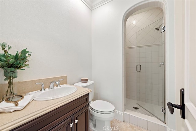 bathroom featuring tile patterned floors, vanity, a shower with shower door, and toilet