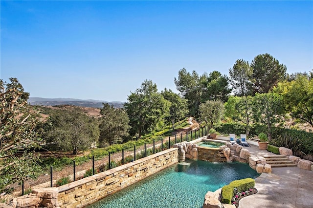 view of swimming pool with an in ground hot tub and pool water feature