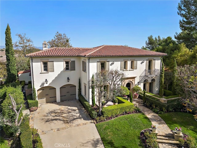 mediterranean / spanish-style house featuring a balcony and a garage