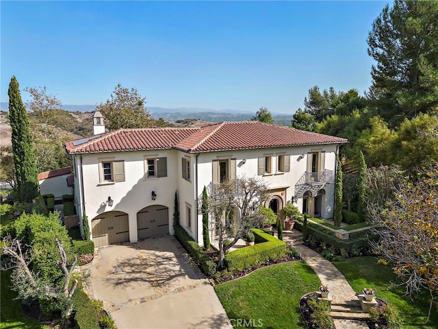 mediterranean / spanish home with a garage