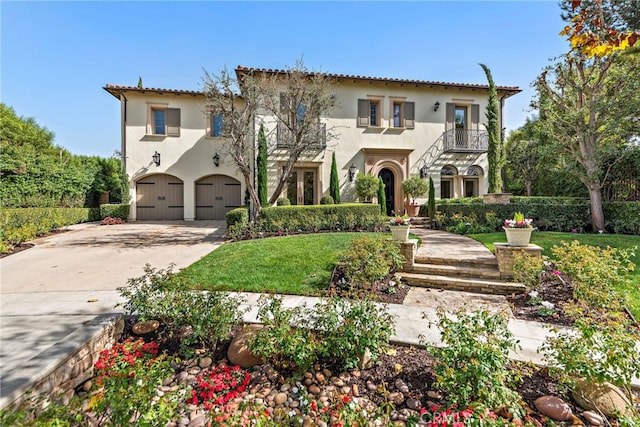 mediterranean / spanish-style home featuring a balcony, a front lawn, and a garage