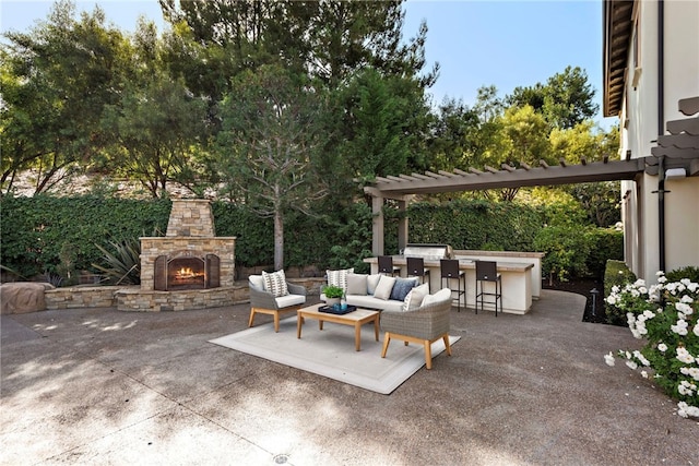 view of patio featuring an outdoor living space with a fireplace, exterior kitchen, and a bar