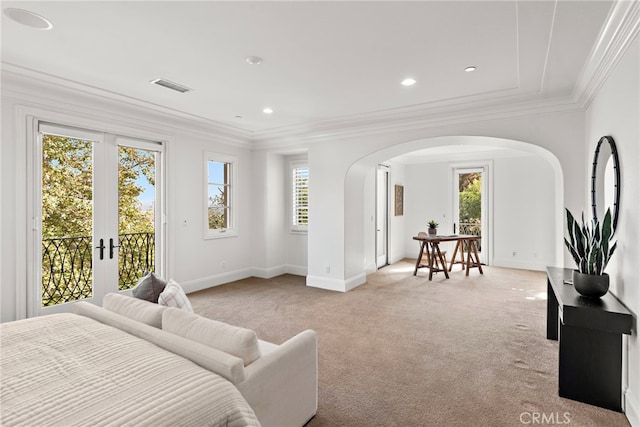 carpeted bedroom with ornamental molding, access to outside, and multiple windows