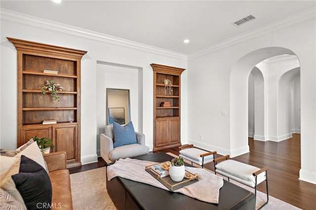 living room with dark hardwood / wood-style flooring and crown molding