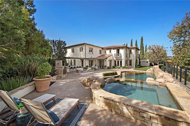 view of swimming pool featuring a patio and an outdoor fireplace